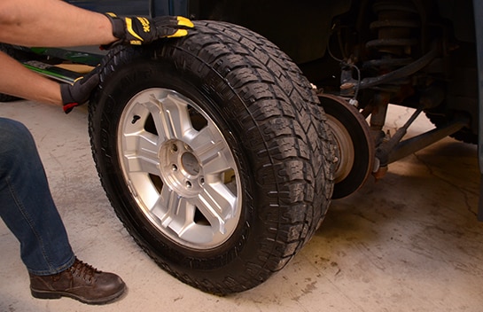 The front wheel of the Silverado 1500 being rolled away